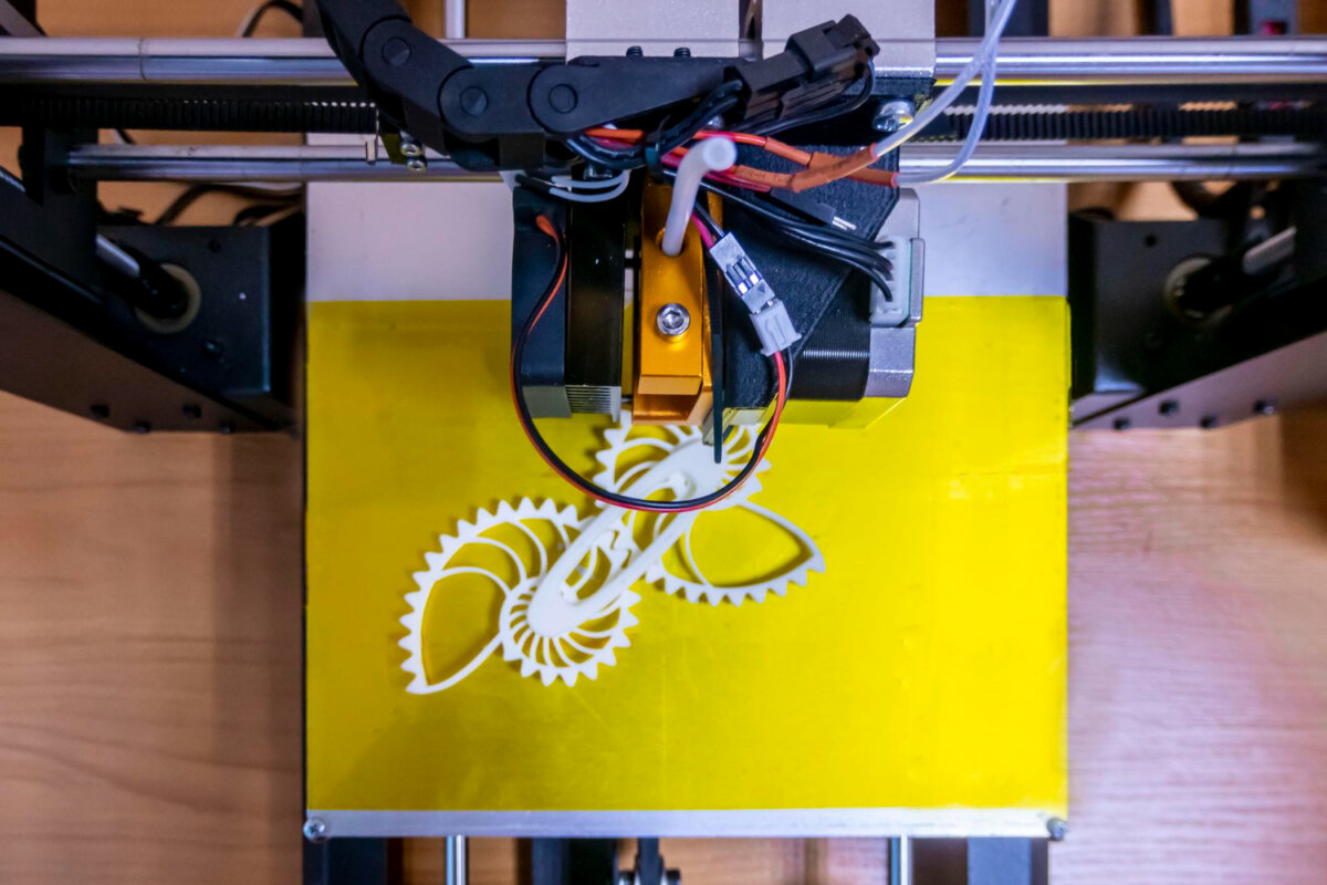 modern-3d-printer-printing-figure-closeup-macro-3d-printer-prints-with-orange-plastic